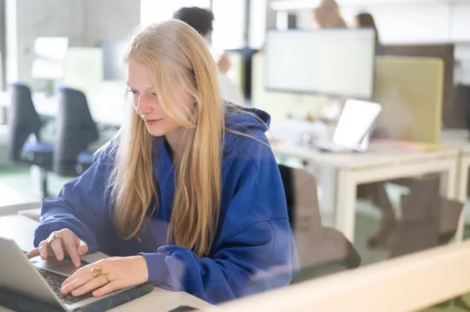Young woman behind computer